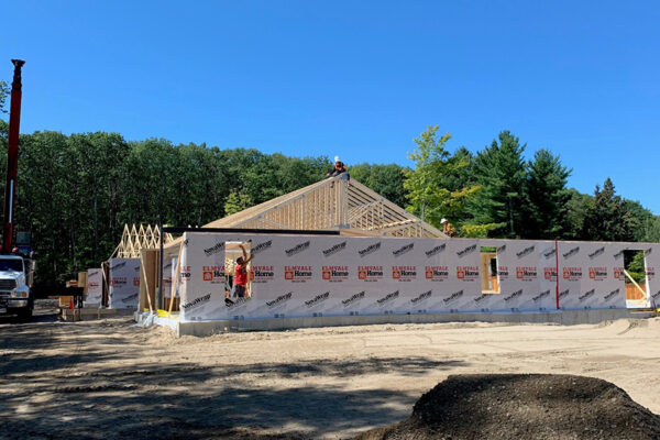 construction workers putting together framing for a new building foundation d framing being added for a commercial building - J.R. Construction LTD - midland on