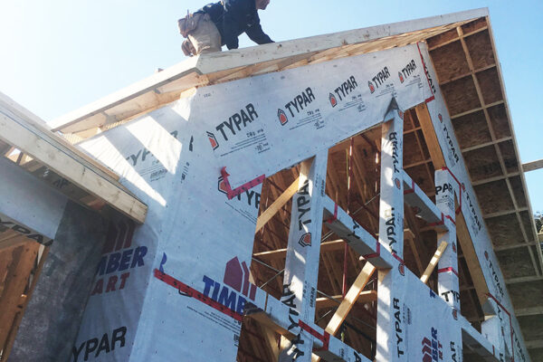 worker on top of roof adding framing for a residential home - J.R. Construction LTD - midland on