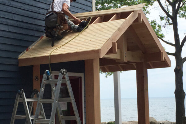worker putting in framing for a door rain cover - J.R. Construction LTD - midland on