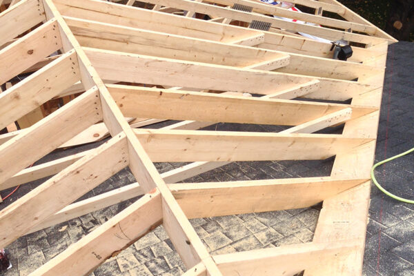 wooden framing of an addition beind added to an existing home arial view photo of the framing of a roof of a home - J.R. Construction LTD - midland on
